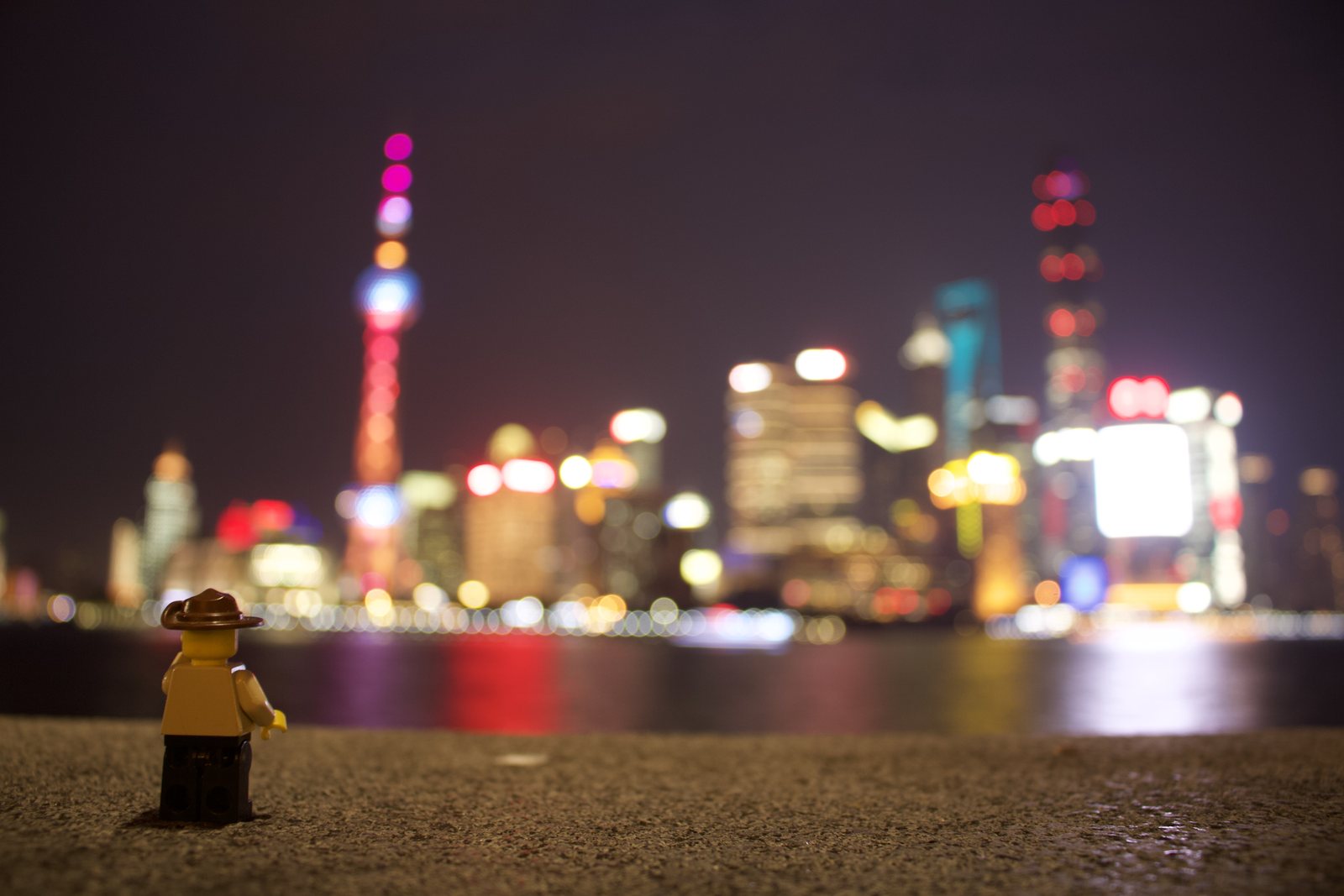 A Lego figure on the Bund, the Pudong skyline behind it